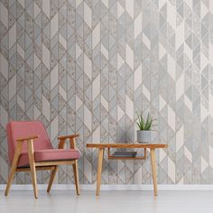 two chairs and a table in front of a wall with geometric tiles on it, one has a potted plant