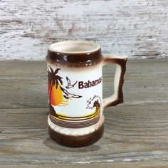 a brown and white coffee mug sitting on top of a wooden table