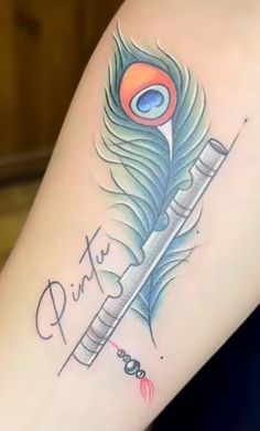 a tattoo with a peacock feather on the side of a woman's leg and writing in cursive ink