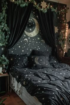 a bed with stars and moon decorations on the headboard, along with black drapes