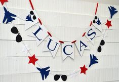 a patriotic fourth of july banner hanging on a wall with sunglasses and stars around it