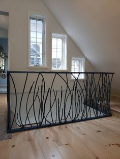 an empty room with two windows and a metal railing