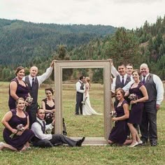 a group of people posing in front of a mirror