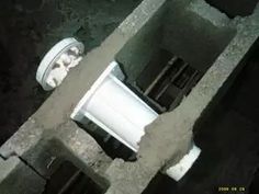 an aerial view of a toilet in the middle of a cement structure with white pipes