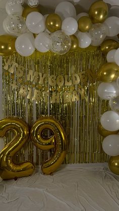 the balloons and streamers are all over the room for this twenty year old birthday party