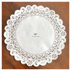 a white doily sitting on top of a wooden table