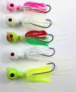 five different types of lures are lined up on a white surface, one is green and the other is pink