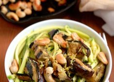 a white bowl filled with food on top of a wooden table