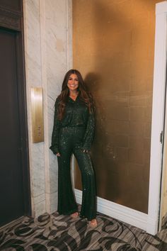 This sophisticated hunter green pants set is made with a luxurious and eye-catching sequin material. It features a collared neckline with shoulder pads, high waisted pants with a side zipper closure and a flared bottom. Whether you're stepping out for a special event or celebrating a holiday, you'll be sure to make a statement in these sequin pants. 100% Polyester Lined Model is 5'6" with a 35" bust, a 26" waist, and 36" hips wearing a size small. 32" inseam Size Rec: 0-2:S, 4-6:M, 8:L Hunter Green Pants, Sequin Material, Sequin Pants, Green Pants, Stepping Out, Hunter Green, A Holiday, Pants Outfit, Holiday Outfits