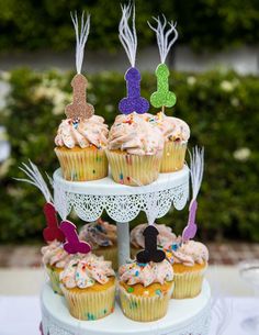 cupcakes with frosting and decorations on a cake stand