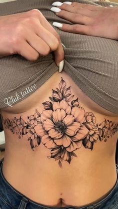 a woman with a flower tattoo on her stomach