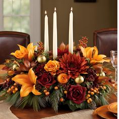 a centerpiece with candles and flowers on a table