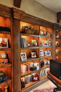 the bookshelves are filled with pictures and photographs