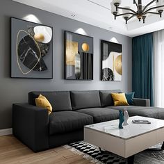 a modern living room with grey couches and yellow pillows on the coffee table in front of two paintings