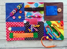 an assortment of crafting supplies laid out on a wooden table with polka dot fabric