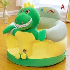 a green and yellow toy sitting on top of a wooden floor