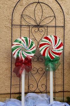 two candy lollipops sitting on top of each other in front of a window