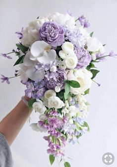 a bridal bouquet with purple and white flowers