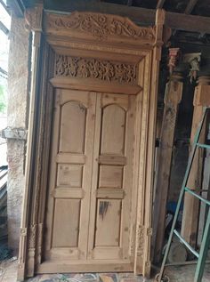 an old wooden door in the middle of a room with other items on the floor