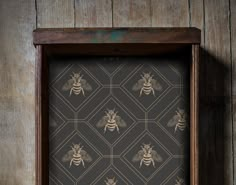 a wooden frame with a bee pattern on it