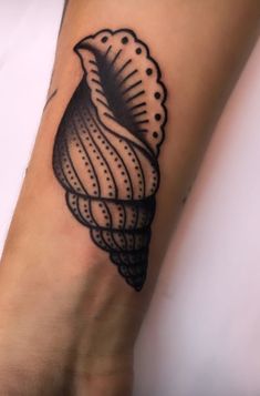 a woman's foot with a black and white tattoo on it