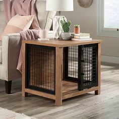 a living room with a couch, chair and dog crate on the coffee table in front of it