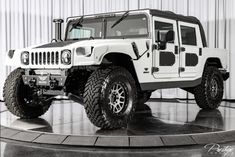 a white jeep parked on top of a black and white floor