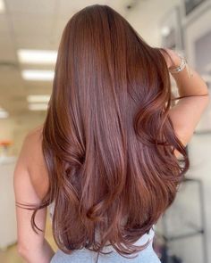 the back of a woman's head with long red hair