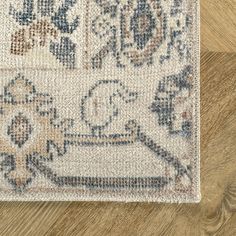 an area rug on the floor with wood floors in the background and a wooden floor