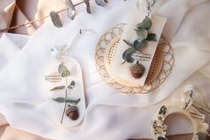 some cookies are sitting on a plate with leaves and other decorations around them, along with ribbons