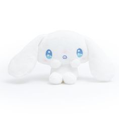 a small white stuffed animal with blue eyes