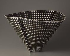 a black and white checkered bowl on a gray background