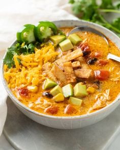 a white bowl filled with soup and vegetables