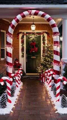 christmas decorations and candy canes in front of a house decorated for the holiday season