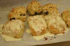 biscuits covered in white icing sitting on top of a piece of parchmented paper