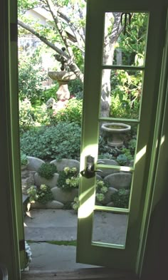 an open green door leading to a garden