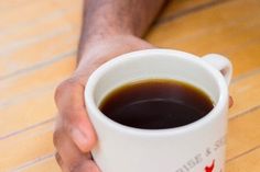 a person holding a cup of coffee in their hands