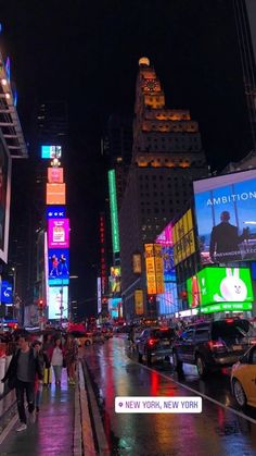 people are walking down the street in times square at night, with brightly lit buildings and billboards