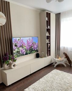 a living room filled with furniture and a large flat screen tv mounted to the wall