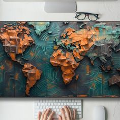 a person typing on a keyboard in front of a large world map wall hanging above them