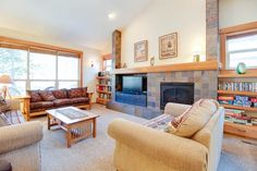 a living room filled with furniture and a fire place in front of a flat screen tv