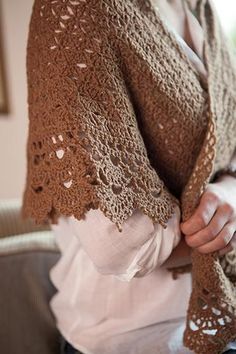 a woman wearing a brown shawl and white shirt