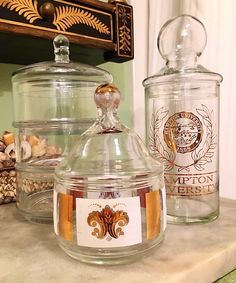 two glass jars sitting on top of a counter