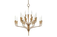 a gold chandelier with white candles hanging from it