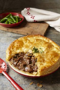 a beef pot pie with a slice cut out