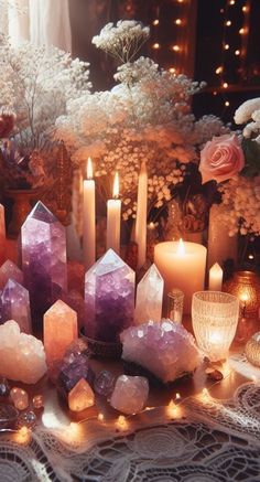 candles and crystals on a table with flowers