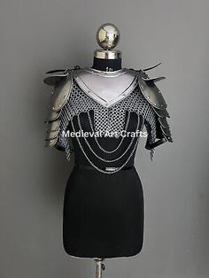 a mannequin wearing a black dress with silver accents