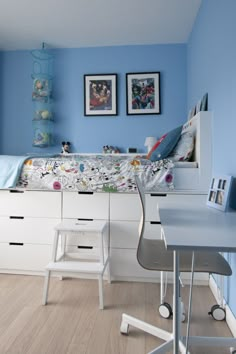 a bedroom with blue walls and white furniture