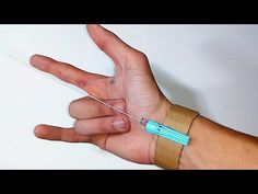 a hand with an iv attached to it and a bandage around the wrist that has a needle in it