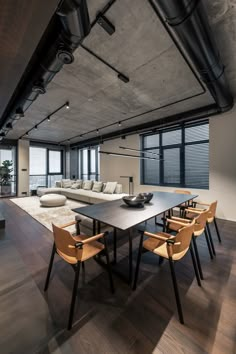 an open living room and dining area with large windows